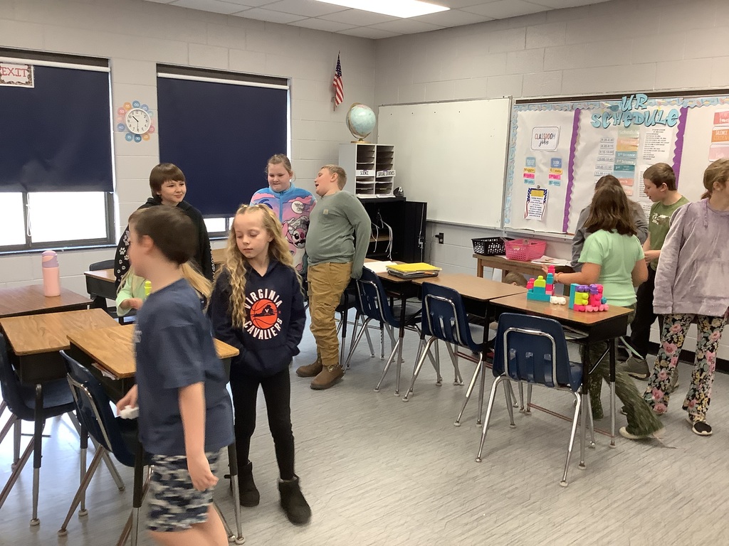 Students are building with blocks at their desks.