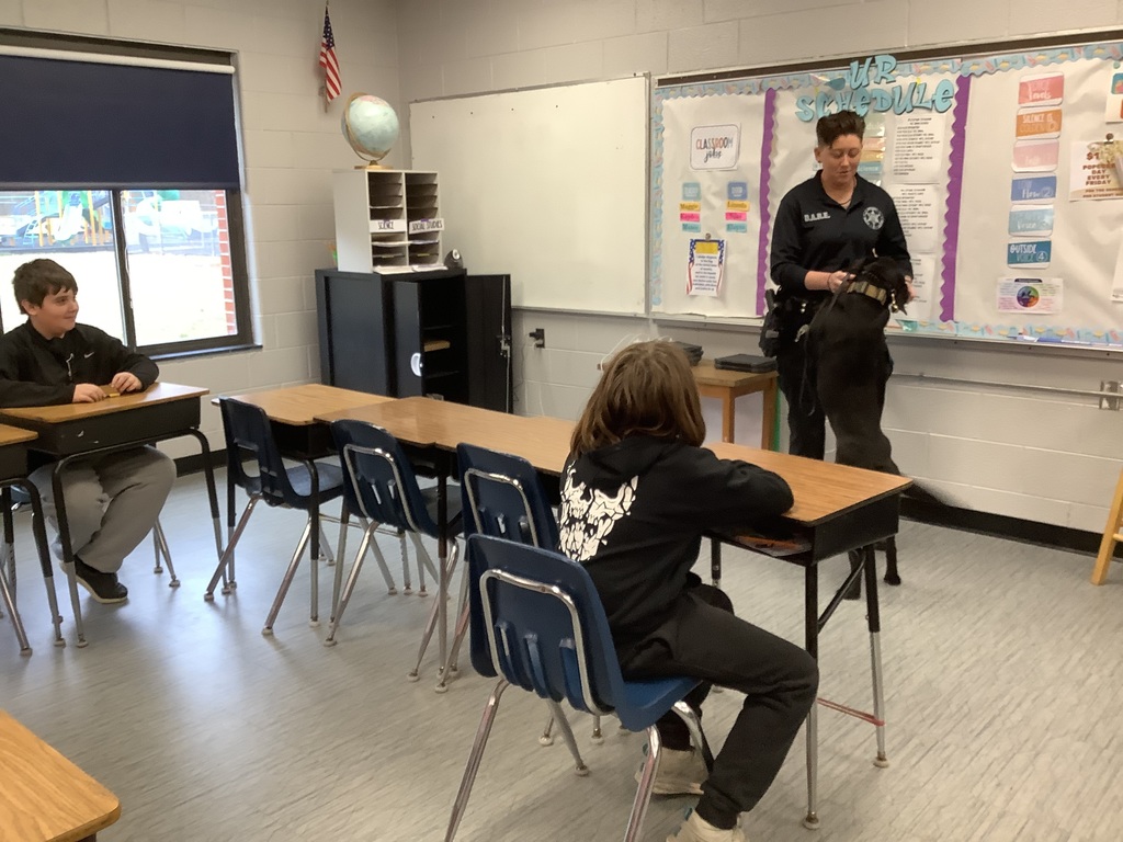 D.A.R.E. officer is speaking to 5th grade. 