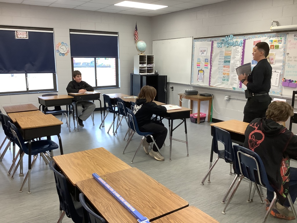 D.A.R.E. officer is speaking to 5th grade. 