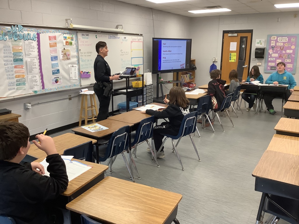 D.A.R.E. officer is speaking to 5th grade. 