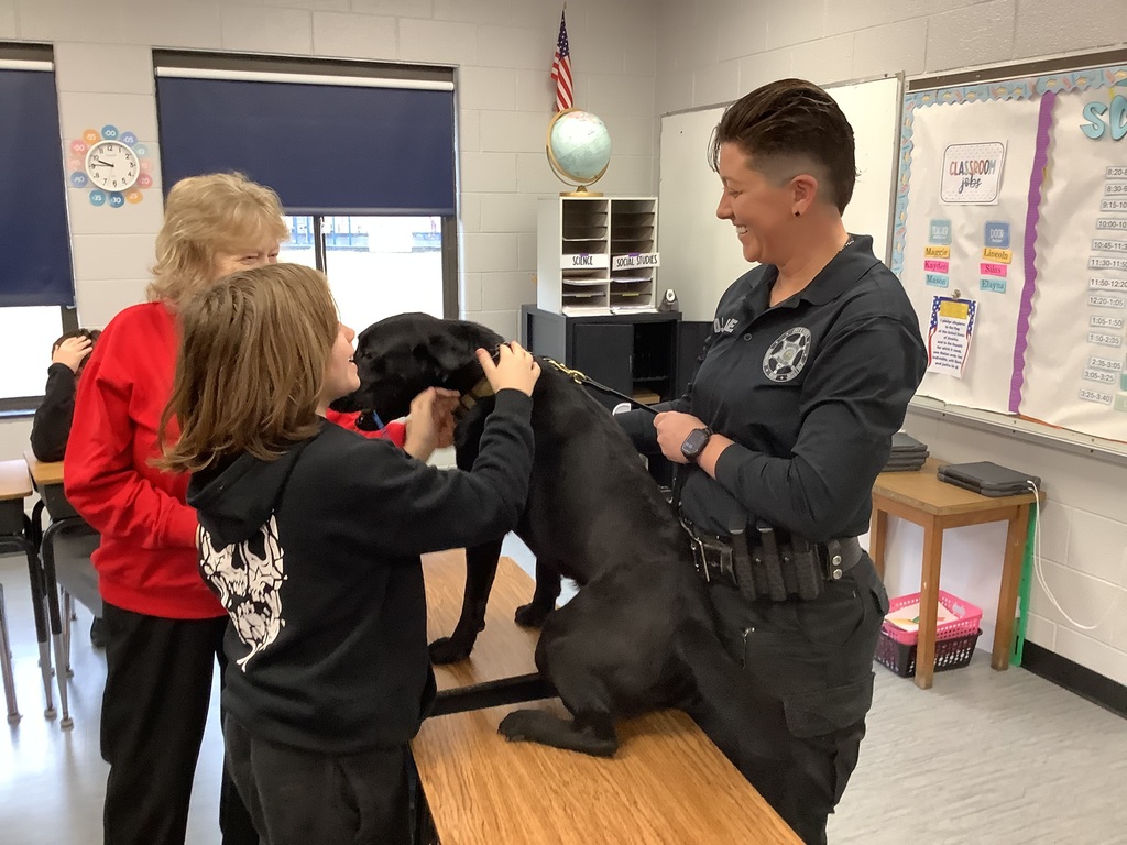 5th grade students get to meet the D.A.R.E. officers police dog. 