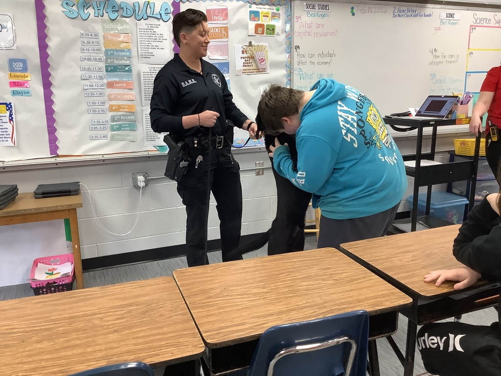 5th grade students get to meet the D.A.R.E. officers police dog.  They give him hugs.