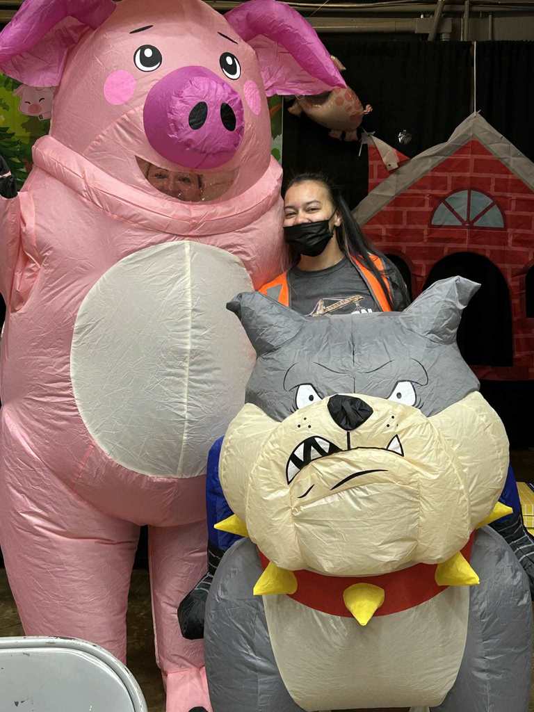 Teacher's Aide in Bulldog Costume at Pre-K Expo with a teacher from another school in an inflatable pig costume