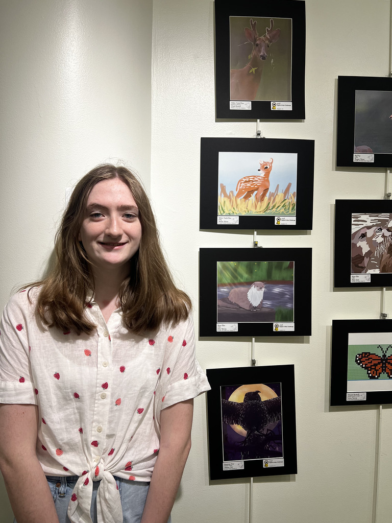 Chloe 8th grade with her art of an otter