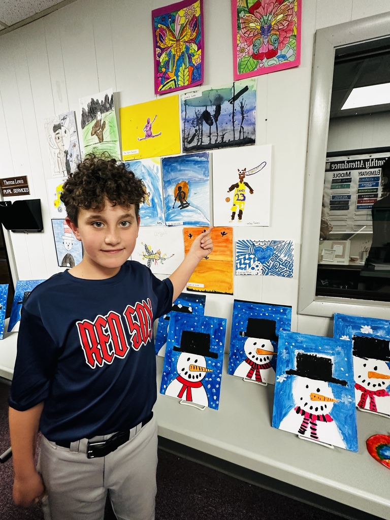 Jackson R showing his drawing created with help from ArtCart at the Night of the Arts. 