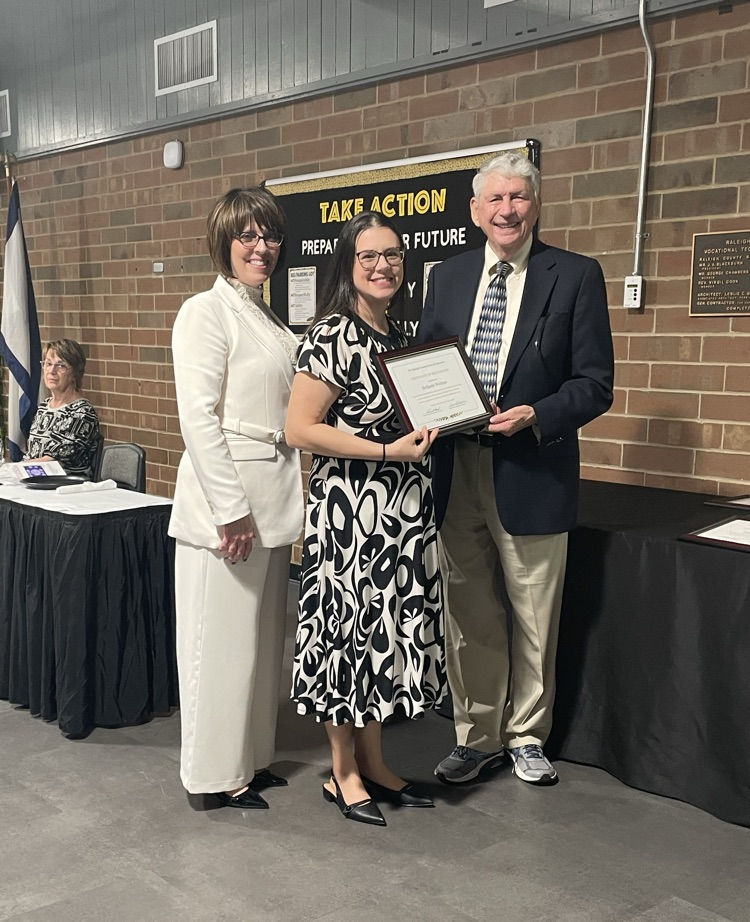 Mrs Weimer and two others holding a plaque for Teacher of Year