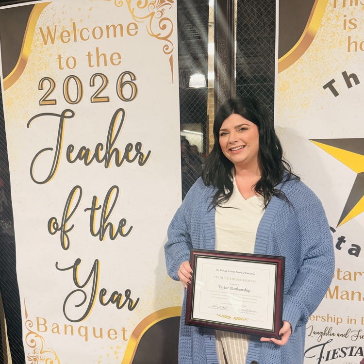 Taylor Blankenship posing with a certificate of teacher of the year for Liberty
