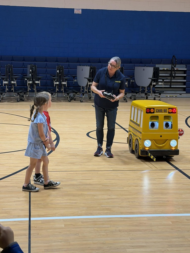 Students demonstrating to the class on how to cross the road to get on the bus.