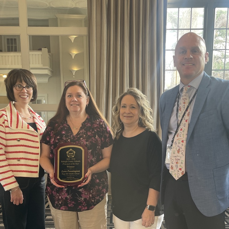 Lora Pennington receiving award for being selected as RCS Principal of the Year. 