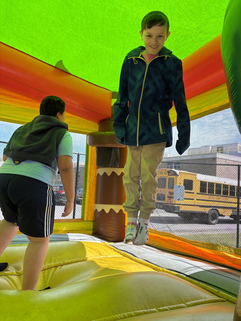 Kevin in mid air in the bounce house. 