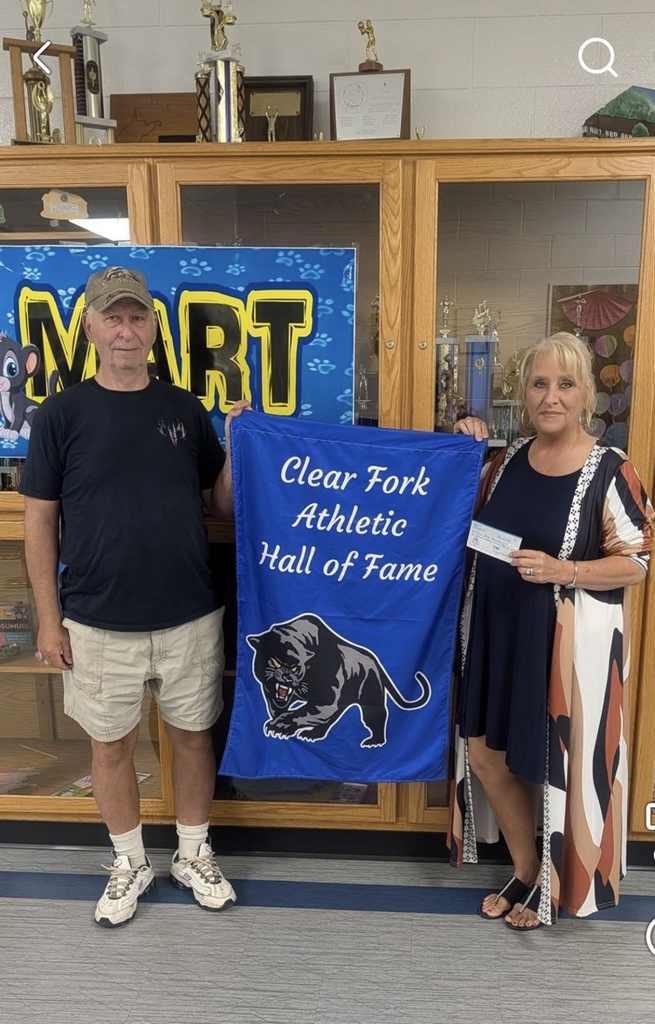 Mark Toney and Mrs. Carter with a $1,000 check for sports.