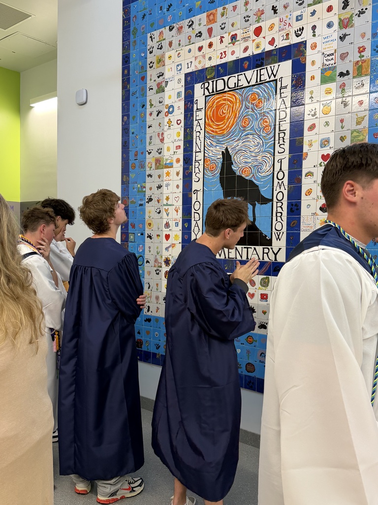 Graduates trying to locate their tile in the Ridgeview Mural