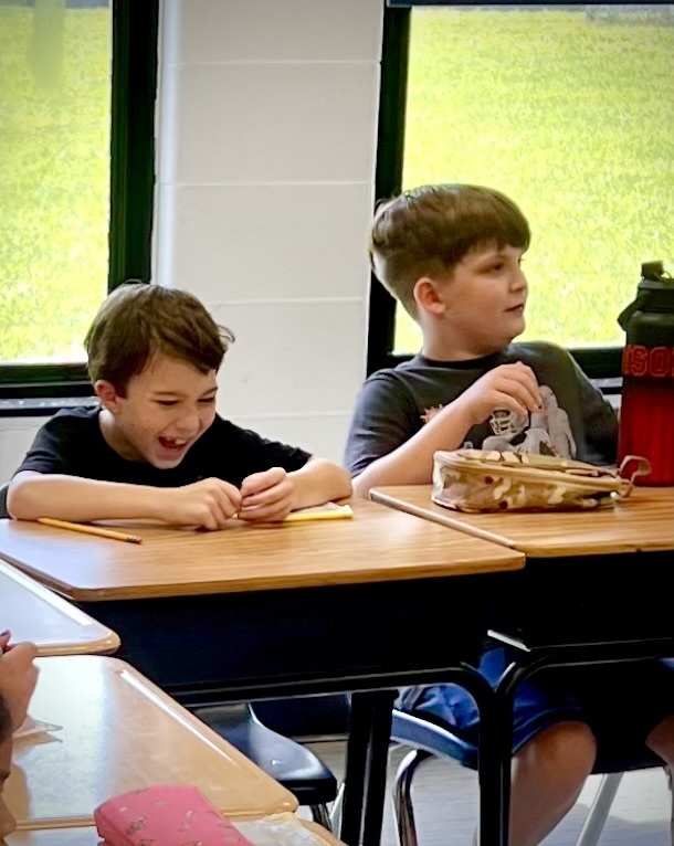 wo male students speaking about an assignment in class.