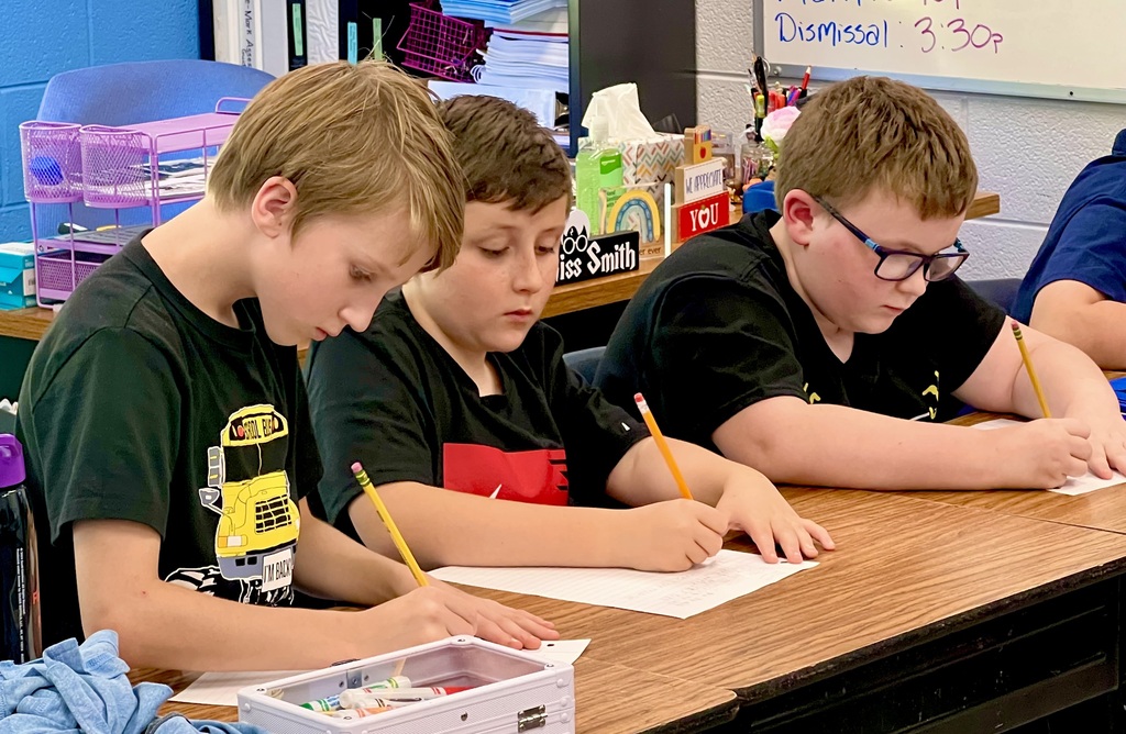 Three Male Students working on an assignment. 