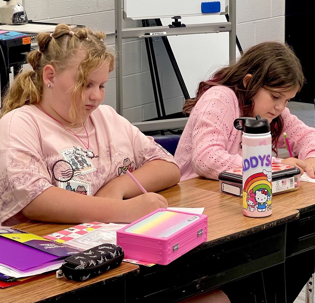 Two Female Students working on a Writing assignment. 