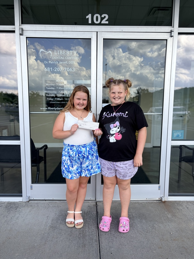 volleyball players with $350 check donated by dr. Jarrell for uniforms.