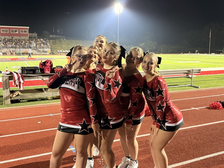 students in cheer uniforms at home game
