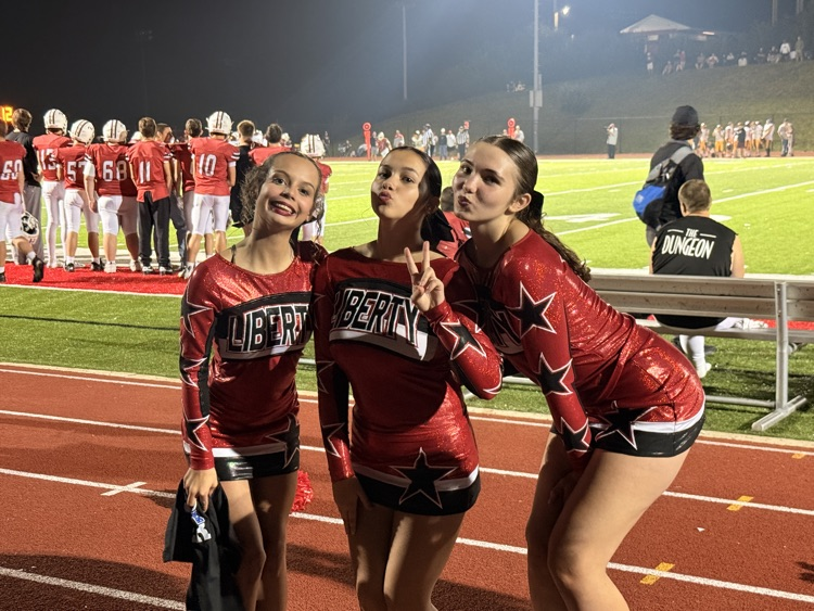 cheerleaders at home game posing for picture 