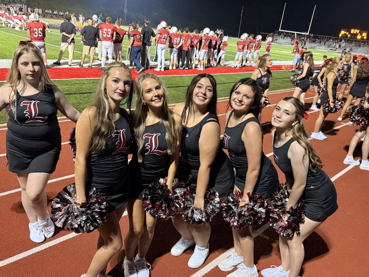 dance team posing for pictures with Pom Pom’s 