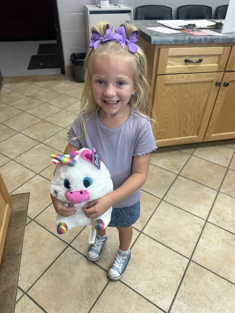 Dani with a stuffed unicorn