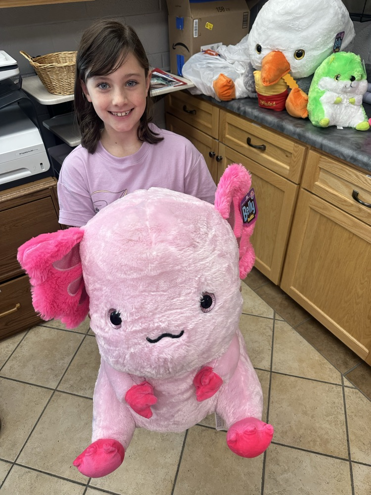 nelle with a stuffed axolotl