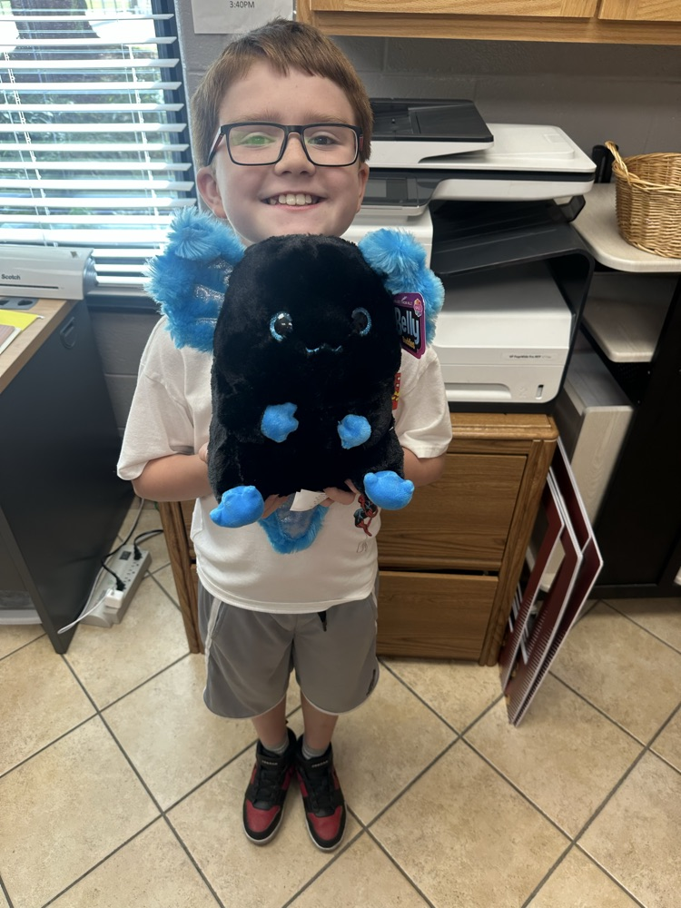 Brody with a stuffed axolotl