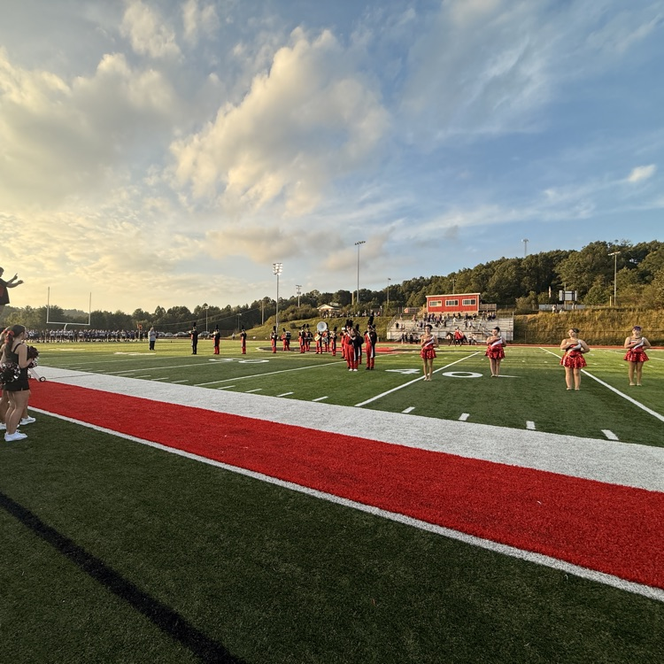 football field with band members