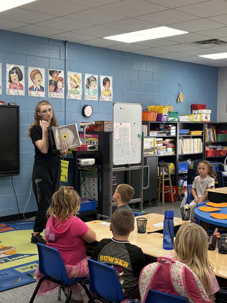 WV Dancer reading a story about emotions to students.