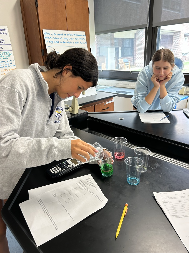A student mixes chemicals. 