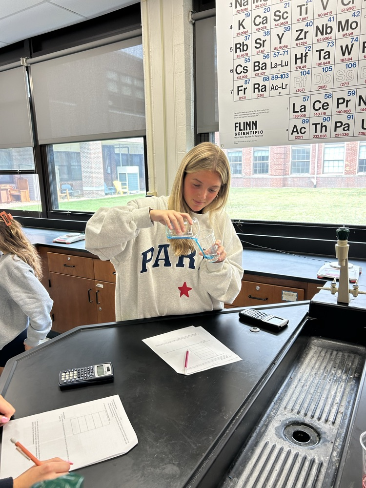 A student mixes substances.