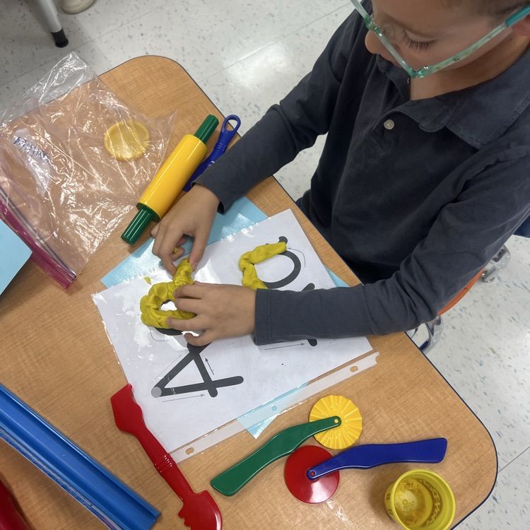 Kindergarten students at Tisdale are having a soft start to their morning by building the letter A with their play dough!