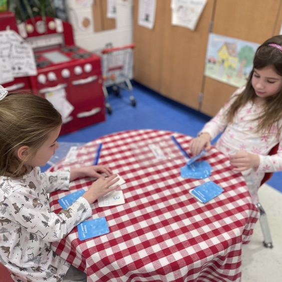 Double Compare - Who has more?Β Β How do you know? K-Col students had fun learning and playing while deciding which pair of cards shows the greater total.