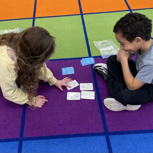 Double Compare - Who has more?Β Β How do you know? K-Col students had fun learning and playing while deciding which pair of cards shows the greater total.