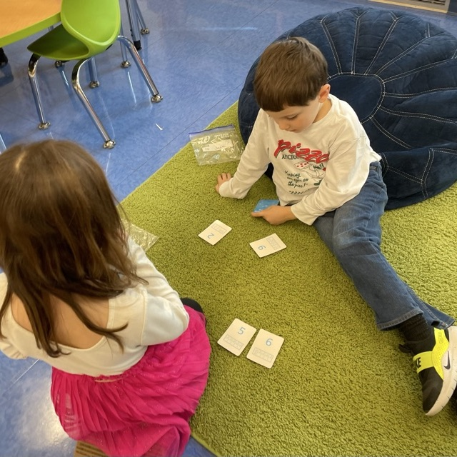 Double Compare - Who has more?Β Β How do you know? K-Col students had fun learning and playing while deciding which pair of cards shows the greater total.
