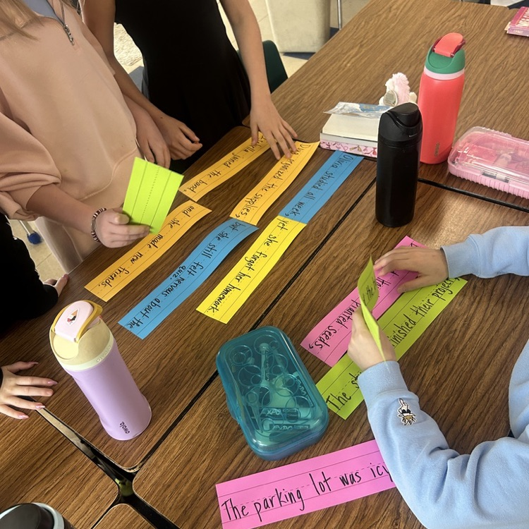 Students in 4 O'Rourke worked together to sort through sentence strips, carefully thinking about grammar rules as they organized the words to create clear and correct sentences.