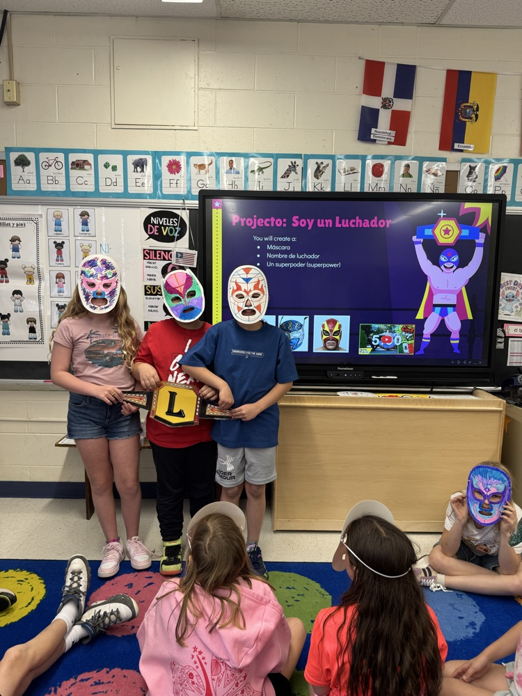students presenting their luchador/luchadora project .