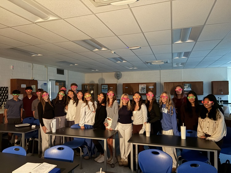 Students pose with diffraction glasses on. 