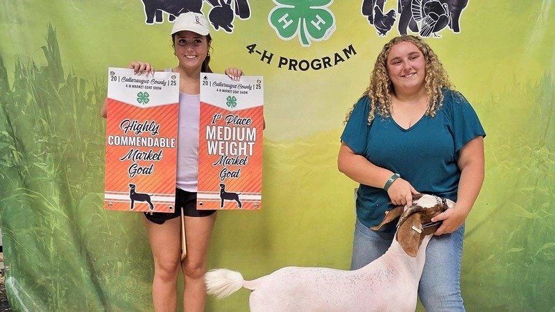 Two students pose with their award-winning goat.