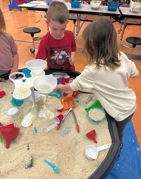 Preschoolers playing in sand