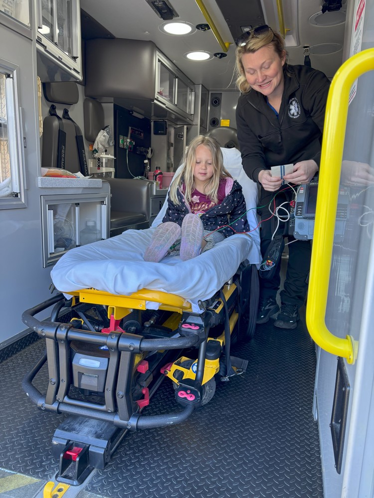 Student with an EMS worker on career day.