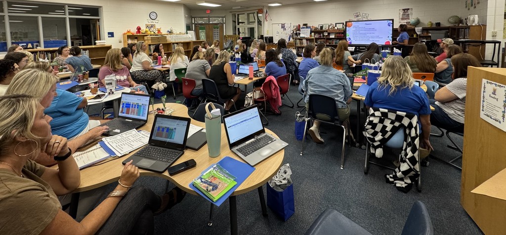 Teachers in the media center during their back to school kickoff meeting!