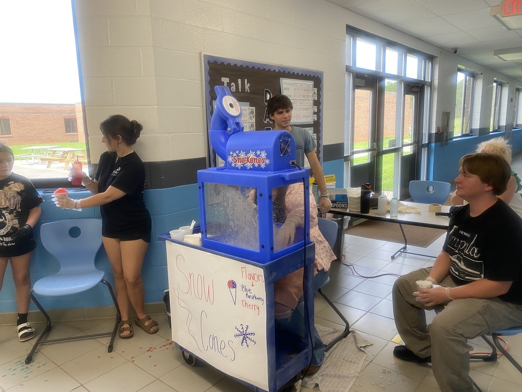 students gathered around a snow cone machine