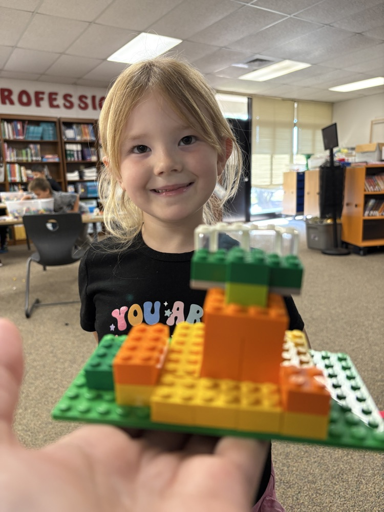 Student holding a Lego pumpkin patch