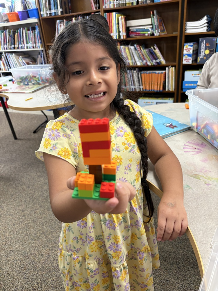 Student holding a Lego Fall tree 