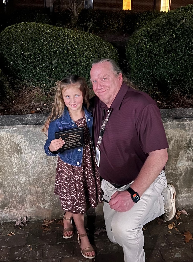Star student Ella Cagle receiving her award with her teacher Mr. Laws.
