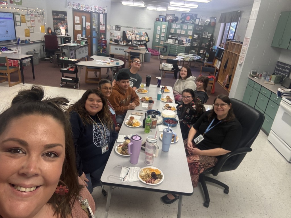 Students and teachers enjoying a classroom Thanksgiving feast