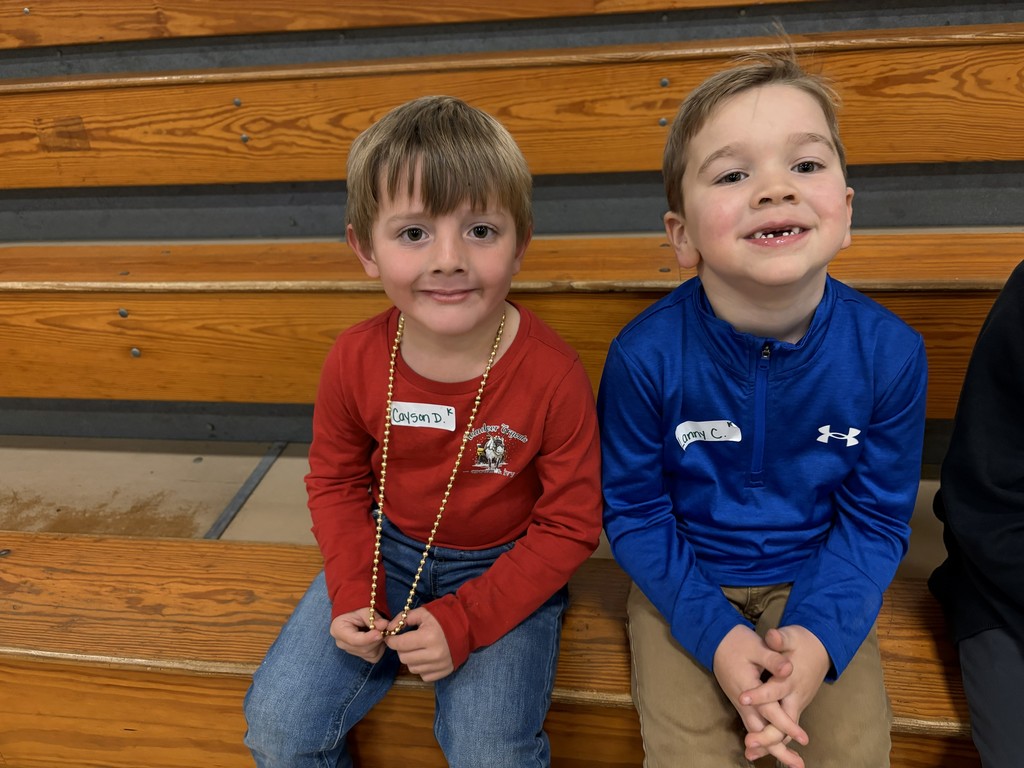Two students sitting on the bleachers in the gym