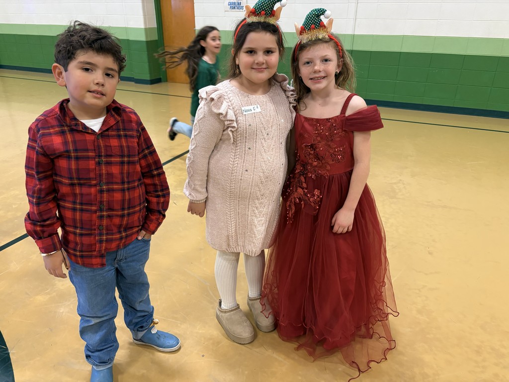 Two girls and a boy smiling during the Jingle Jam.