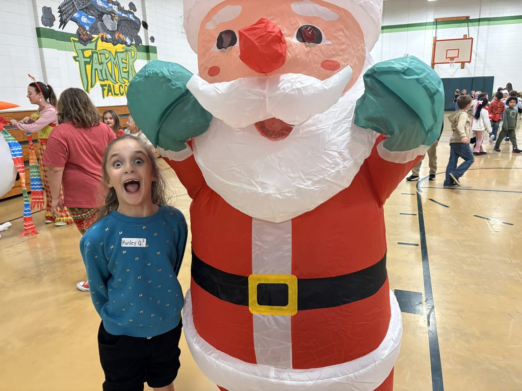 Student standing with Santa