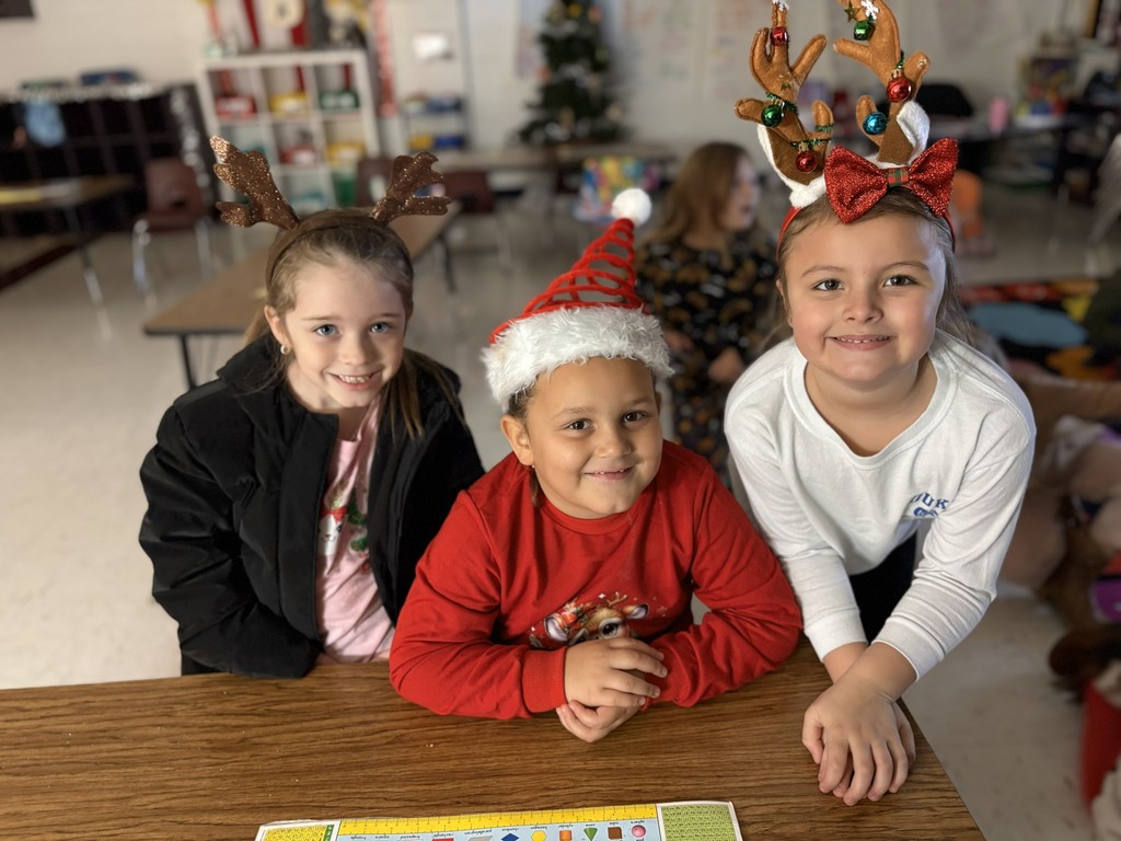 Three students in their holiday hats.
